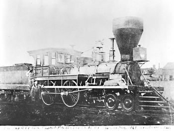 Bytown &amp; Prescott Railway’s locomotive, ”the Ottawa,&quot; taken in 1861 near the King St (King Edward St) crossing by G.W. Edmondson. Mike Mahar, the fireman, is standing between the engine and tender. Standing by the train is Robert Graham, the engineer. Library and Archives, Canada C5288.