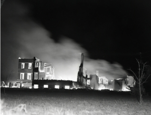 The glowing remains of Villa St-Louis, 15 May 1956.