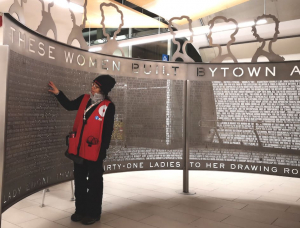 An O-Train ambassador examines the newly installed sculpture at the Lyon LRT sta- tion, which honours the 32 founders of the Women’s Canadian Historical Society of Ottawa — the organization that evolved into today’s Historical Society of Ottawa